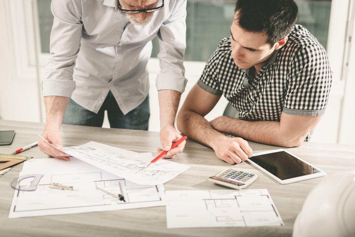 Architects working on plans at office